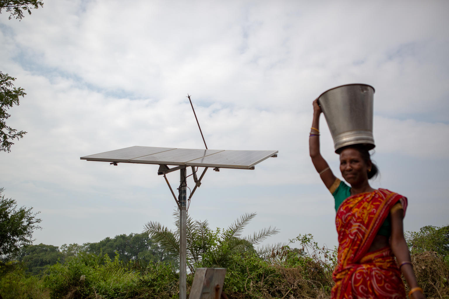 A woman heads home after filling water from a dedicated water filling station at Nuagam village, Rayagada district, Odisha. Nuagam is a tribal village, with a population of about 740 people, who have adapted to a clean and hygienic approach to living, with every villager inculcating the proper use of toilets for sanitation and the use of clean water generated by solar energy to help supplement the water supply to the village leading to a self sustaining environment. Adaptation of water and sanitation infrastructure
