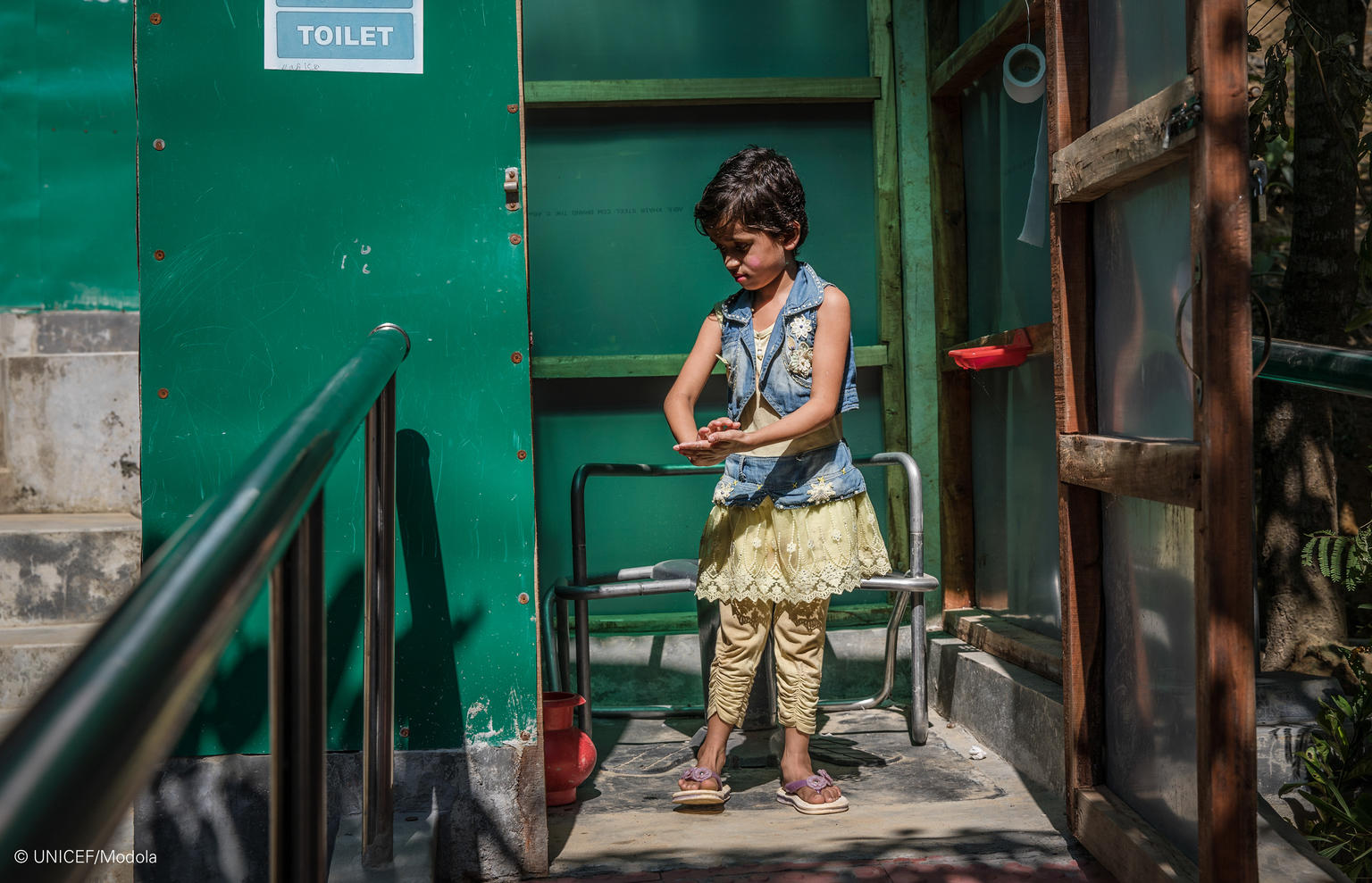 Rajuma, 6, uses a disability-friendly latrine in a learning centre in Camp 16, Balukhali refugee camp in Cox’s Bazar, Bangladesh, November 14, 2019. Rajuma was born with weak knees that keep her from walking far, or to stand for too long. She cannot run at all. She loves attending the learning centre, but she needs help from her friend Meena to walk there every day. Rajuma loves to learn rhymes and enjoys singing “the Banana song”. The disability-friendly latrines are piloted in the Rohingya settlements in Rajuma, 6, uses a disability-friendly latrine in a learning centre in Camp 16, Balukhali refugee camp in Cox’s Bazar, Bangladesh, November 14, 2019. Rajuma was born with weak knees that keep her from walking far, or to stand for too long. She cannot run at all. She loves attending the learning centre, but she needs help from her friend Meena to walk there every day. Rajuma loves to learn rhymes and enjoys singing “the Banana song”.